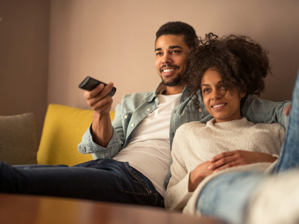 Couple relaxing on the sofa watching Bunny Stream IPTV